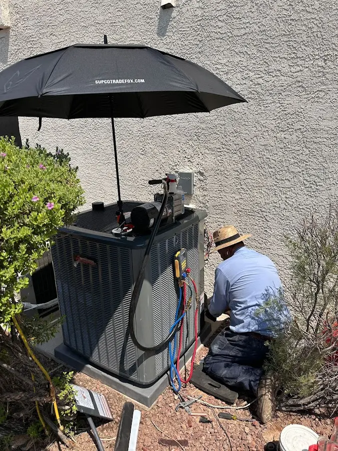 HVAC technician performing outdoor AC maintenance in Oakmont