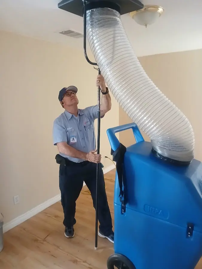 Furnace Tune-Up technician using HEPA equipment in Oakmont