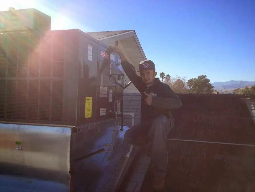 HVAC technician performing HVAC Inspection on a rooftop unit in Oakmont